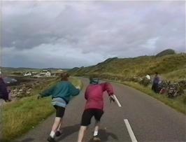 Matthew Pryer and Richard Sudworth race to catch the plastic bag in the strong wind